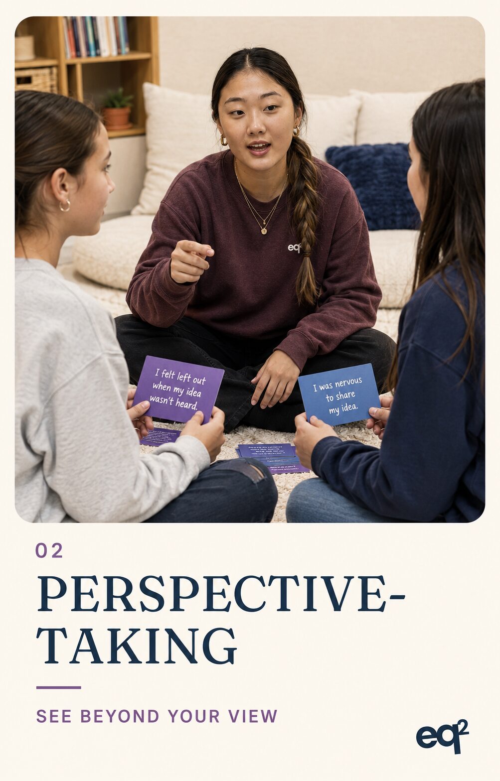 eq2 branded card: Emma Byun sitting cross-legged with two students playing a card-based discussion game, cards reading I felt left out when my idea wasn't heard and I was nervous to share my idea, labeled 02 Perspective-Taking, See Beyond Your View